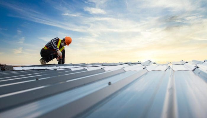 builder working on commercial roof repair