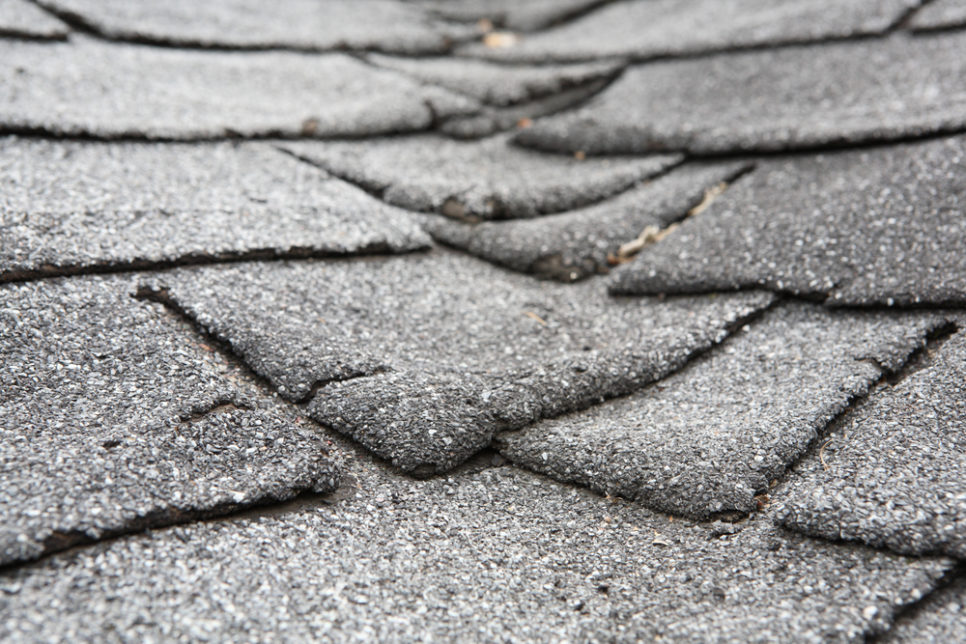 old roof with damage cracked shingles