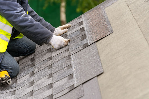 A Roofer Installs Roof Shingles